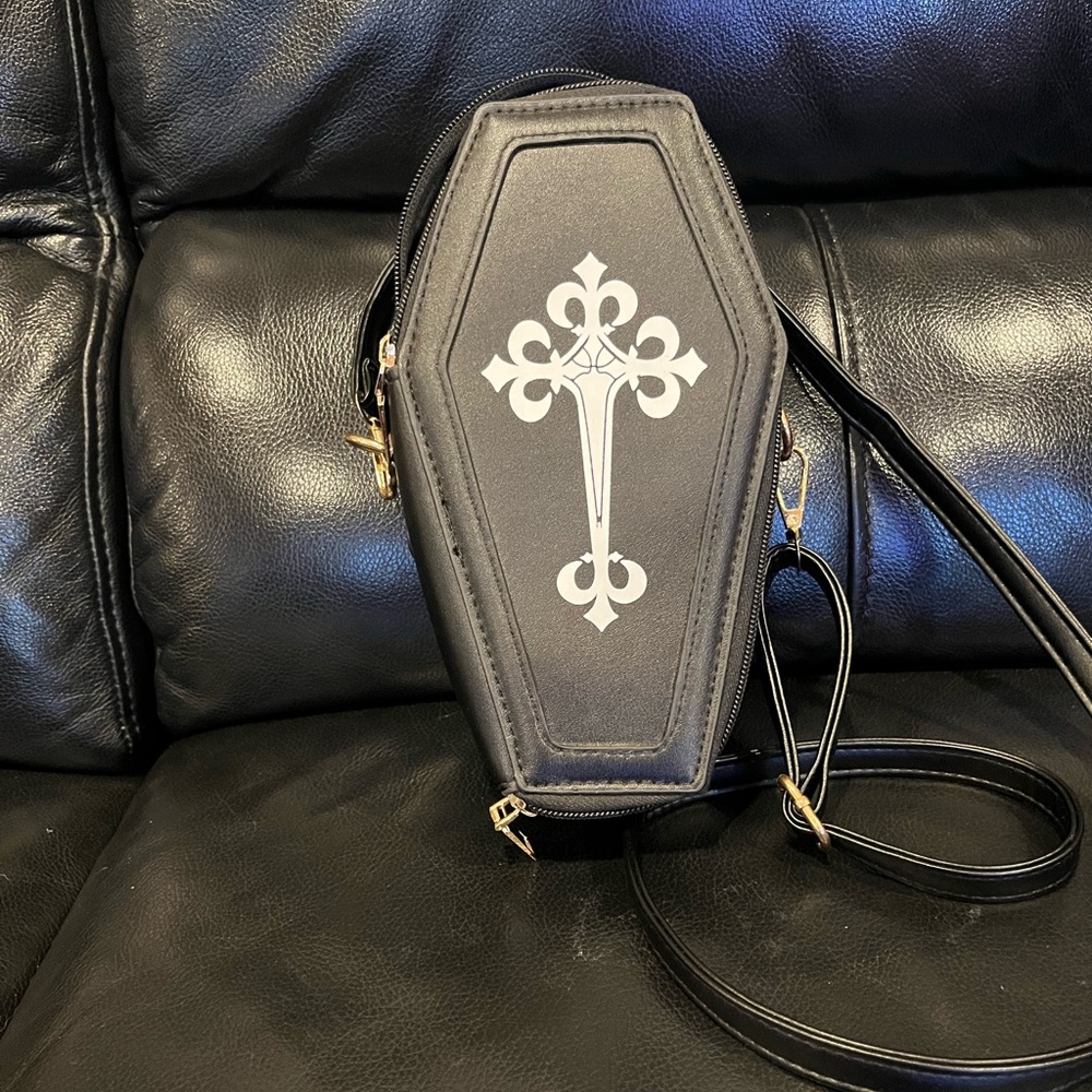 Crossbody Halloween purse. Brand is unknown. Black purse with white cross.
